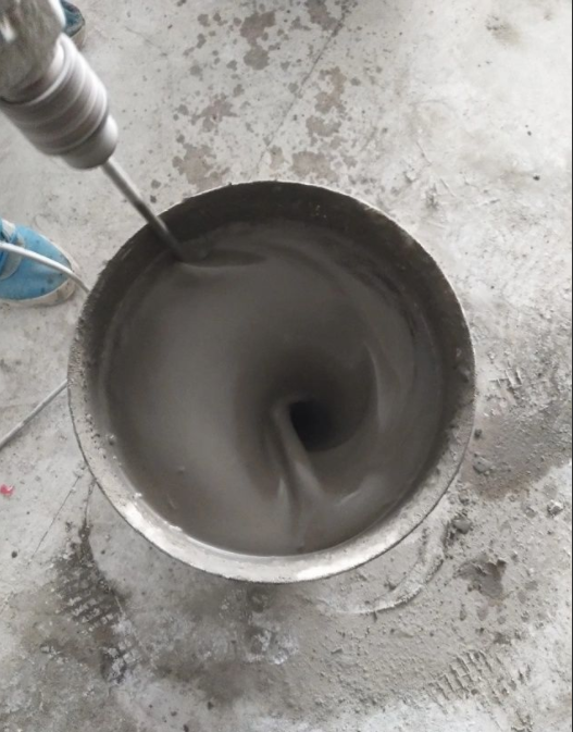 Worker mixing dry YUNYANMIX heavy load self-leveling cement and sand for industrial floor
